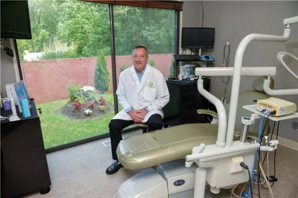 Dr Kostrzewski Dental Exam Room Bethel CT Dr. Walter Kostrzewski in a modern dental exam room at Stony Hill Dental Care, equipped with advanced technology for comfortable patient care in Bethel, Connecticut